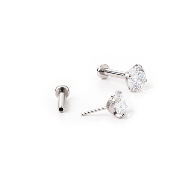 Įstumiamas titano labret su laikiklyje įstatytu akmenėliu